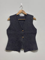 Charcoal grey V-neck sleeveless vest with two gold-tone buttons and shaped waist