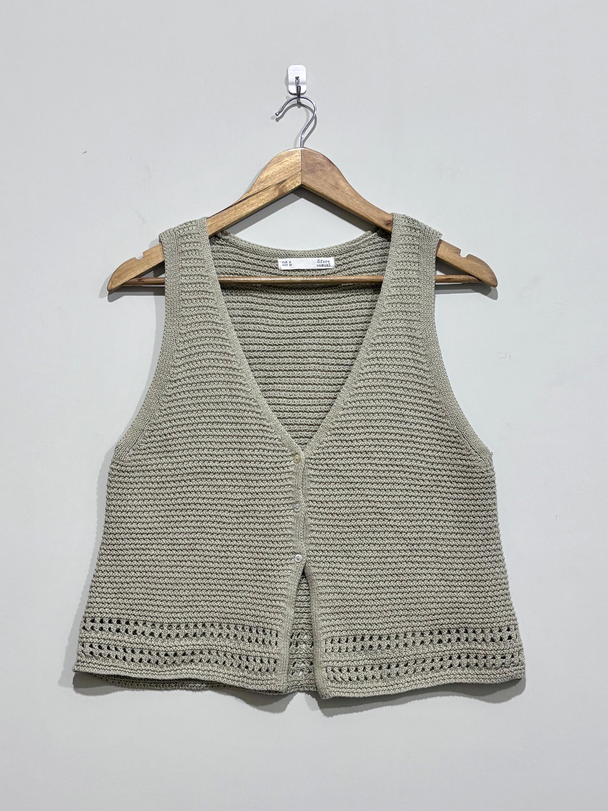 Sage green textured V-neck button-front sleeveless vest with openwork hem