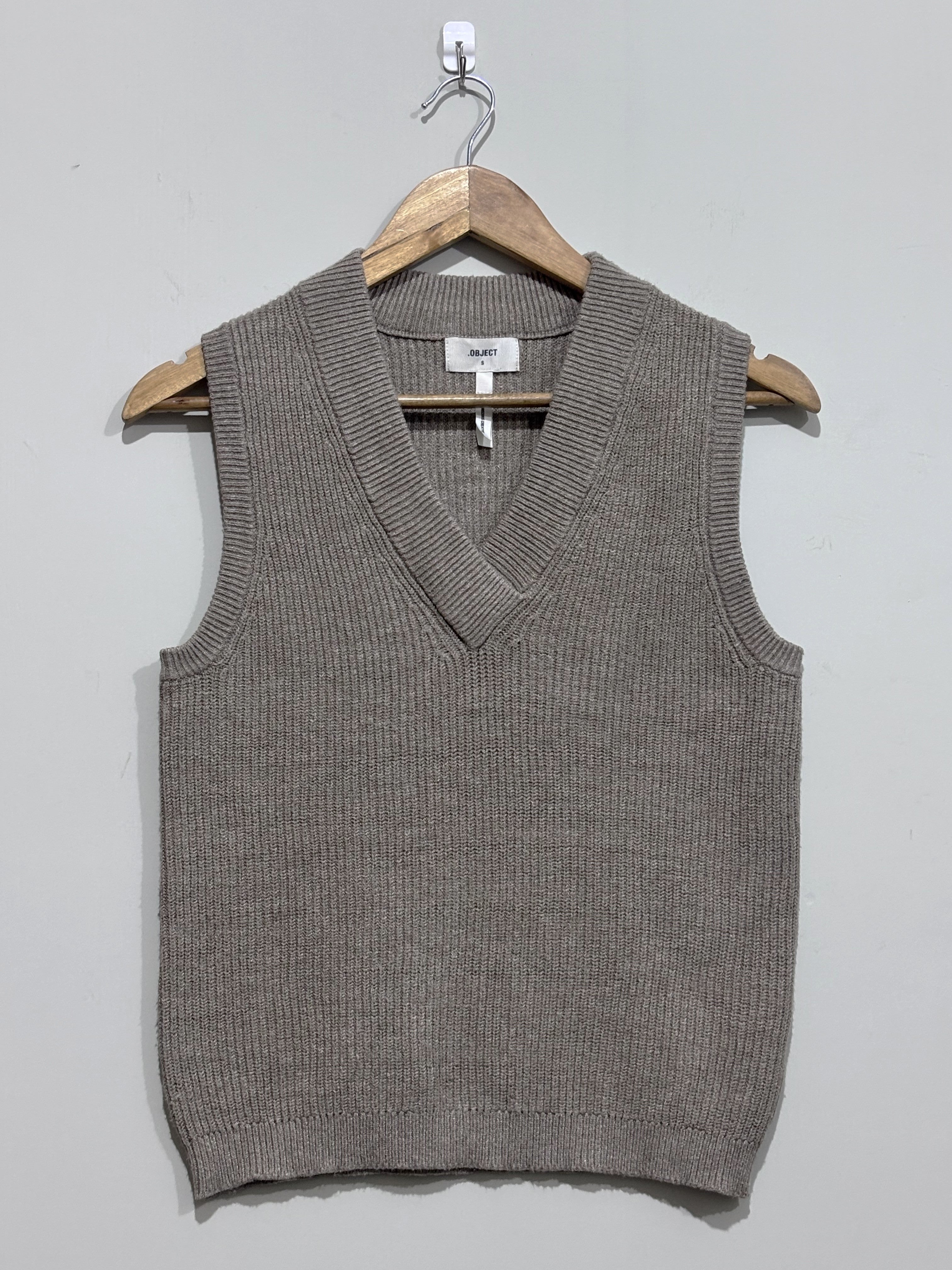 Taupe textured sleeveless sweater vest with a deep V-neck and ribbed edging
