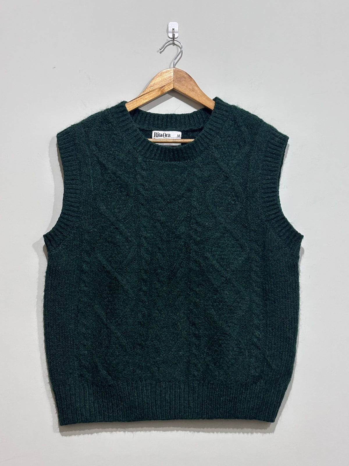 Dark green textured crew-neck sleeveless sweater vest with ribbed trim