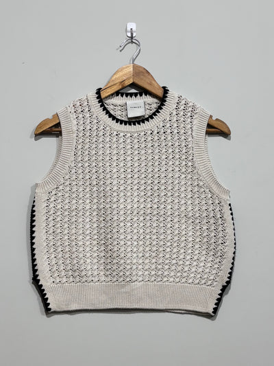 Cream open-knit Varley sweater vest with black contrast stitching at the crew neckline and sides