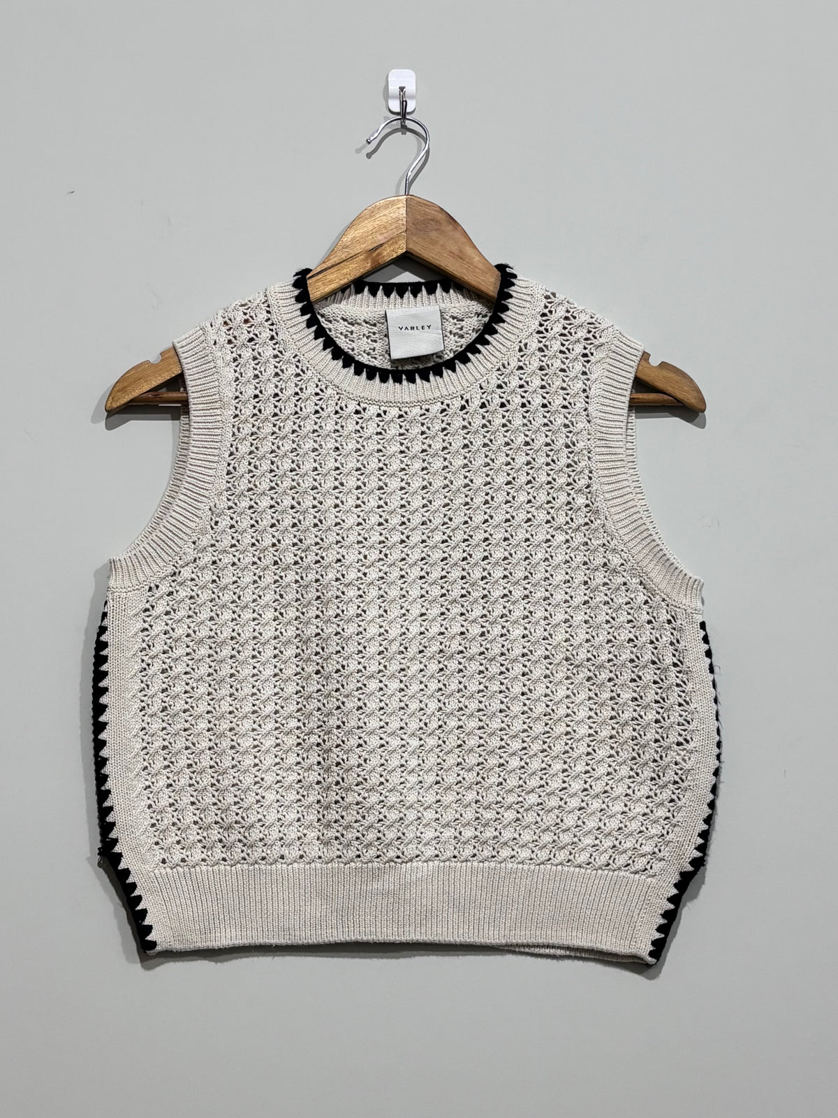 Cream open-knit Varley sweater vest with black contrast stitching at the crew neckline and sides