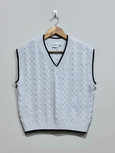 White cable-knit V-neck vest with black contrast trim