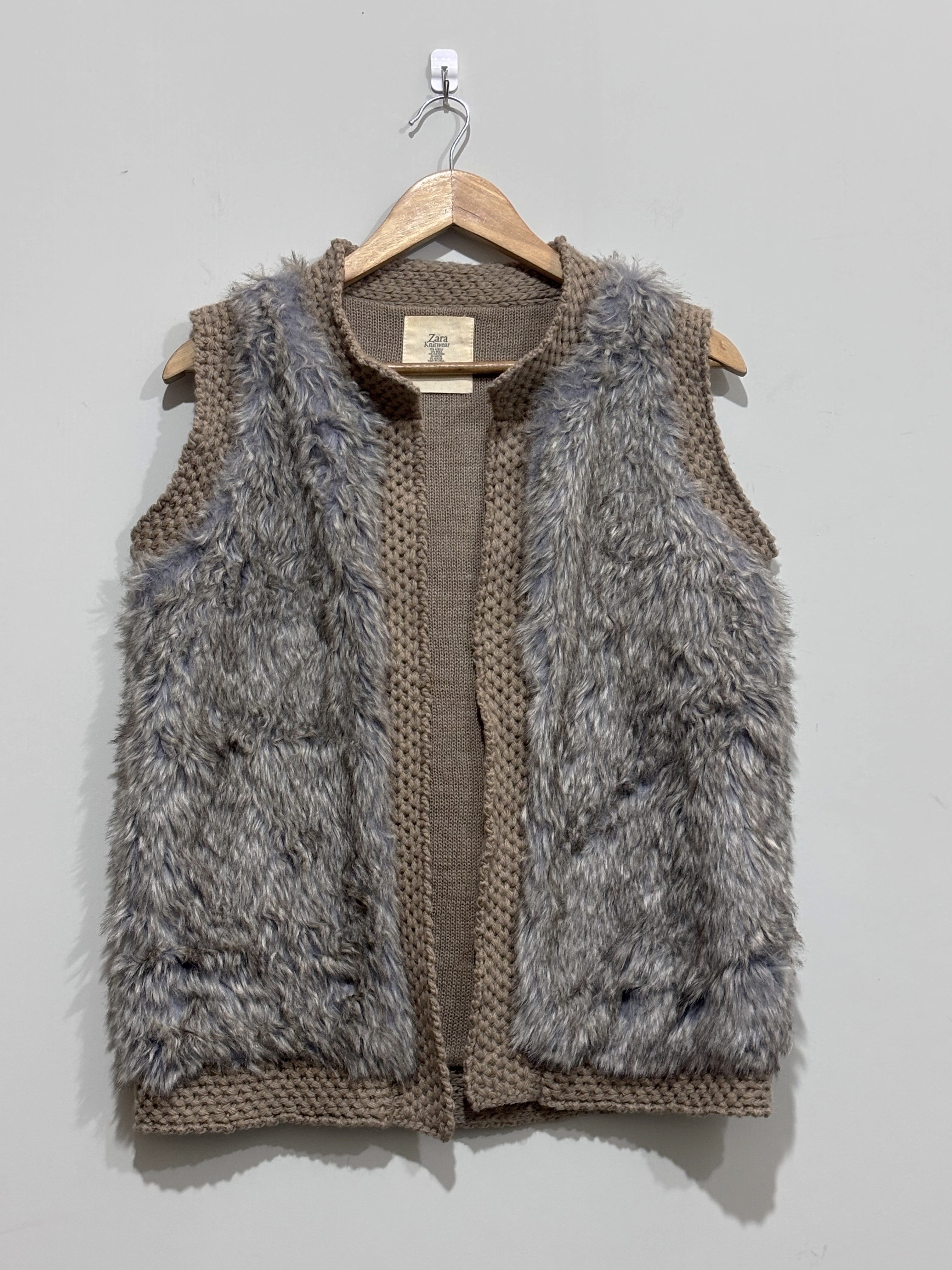 Grey and taupe sleeveless open-front vest with shaggy front panels and chunky-knit edging