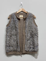 Grey and taupe sleeveless open-front vest with shaggy front panels and chunky-knit edging