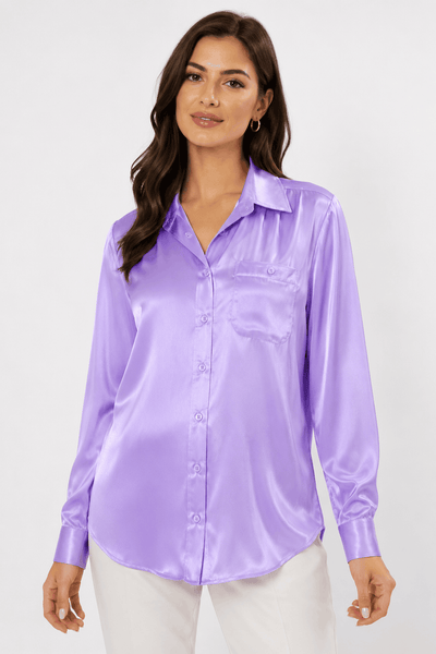 Woman wearing a purple satin shirt against a white background