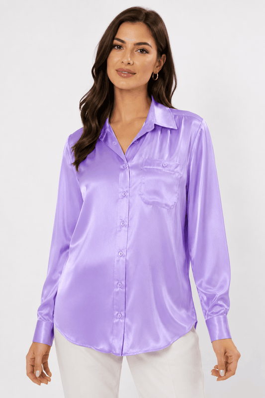 Woman wearing a purple satin shirt against a white background