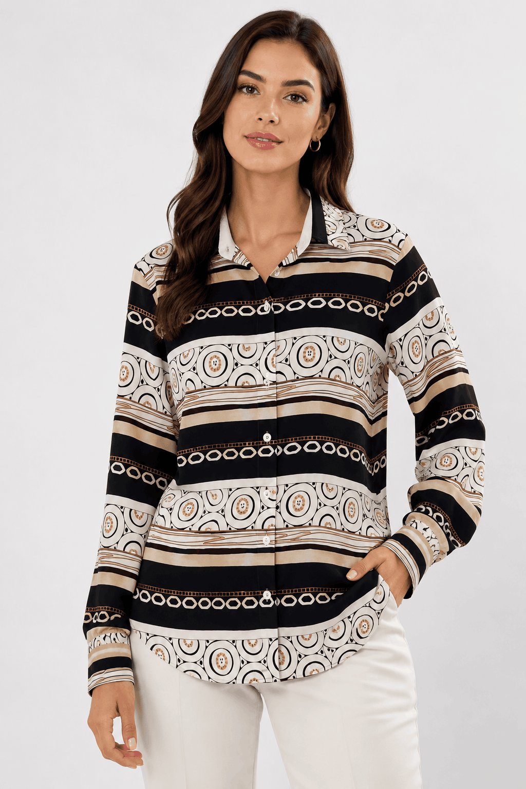 Woman wearing a patterned long-sleeve shirt with a white background