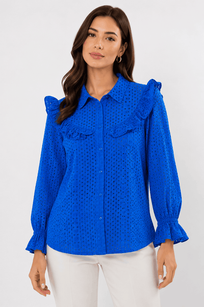 Woman wearing a blue blouse with ruffled details on a white background