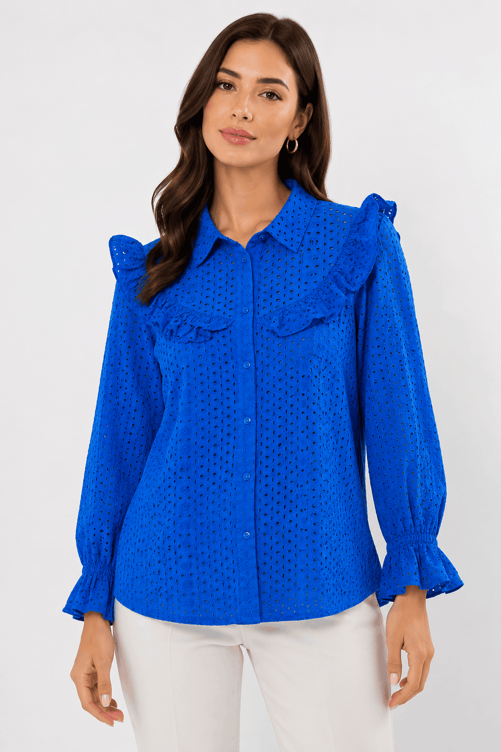 Woman wearing a blue blouse with ruffled details on a white background