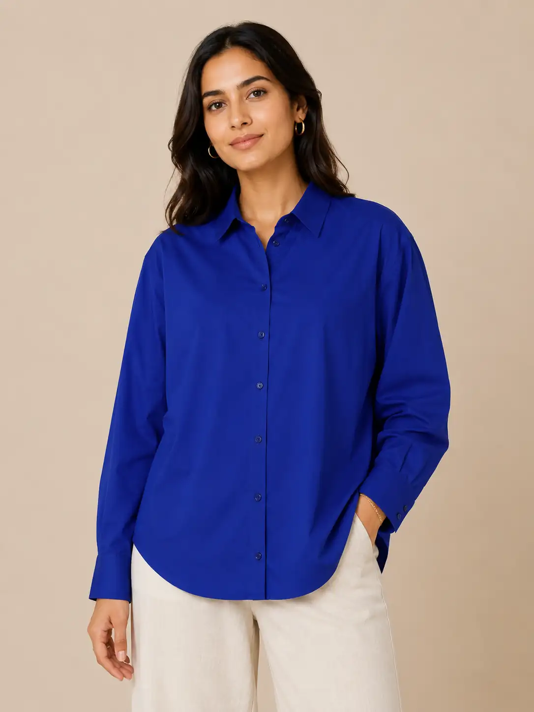 Woman wearing a blue shirt against a beige background