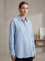 Woman wearing a light blue shirt in an indoor setting