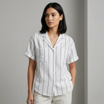 Woman wearing a white shirt with black stripes against a gray background