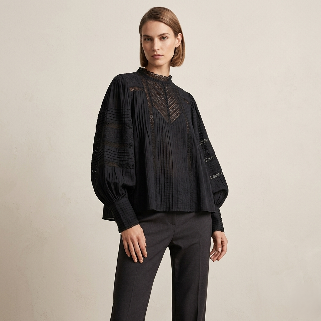 Woman wearing a black textured top and pants on a beige background
