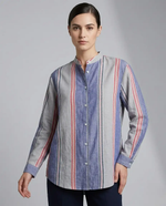 Woman wearing a long-sleeve, button-up shirt with a striped pattern on a gray background