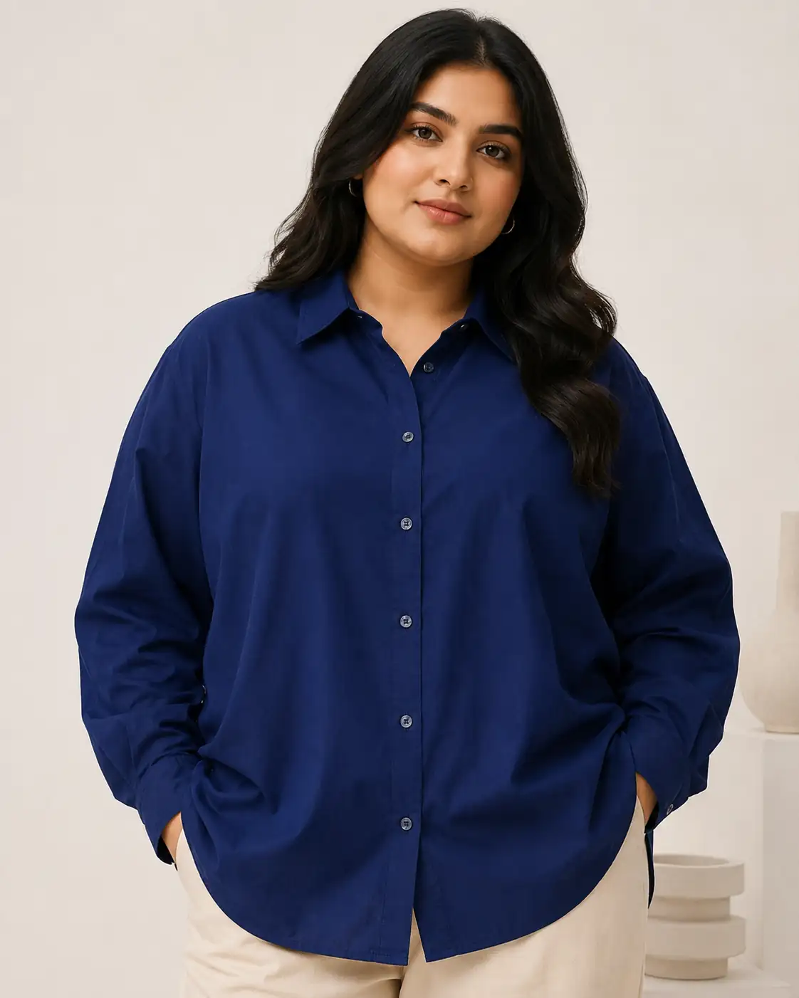 Woman wearing a blue shirt against a plain background