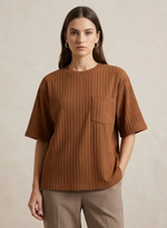 Woman wearing a brown ribbed t-shirt with a pocket on a beige background