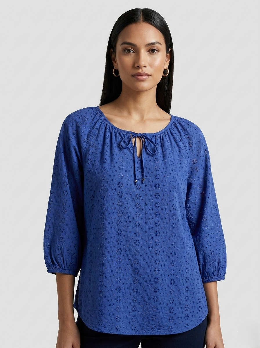 Woman wearing a blue blouse with a white background
