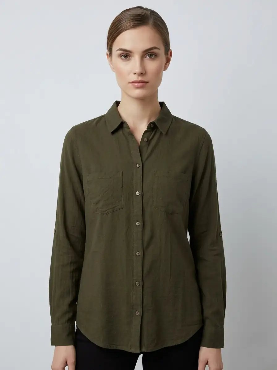 Woman wearing an olive green button-up shirt against a plain background