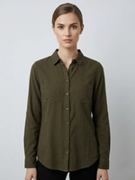 Woman wearing an olive green button-up shirt against a plain background