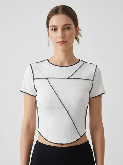 Woman wearing a white geometric-patterned top on a light gray background