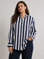 Woman wearing a navy and white striped shirt against a gray background