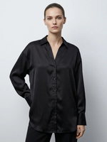 Person wearing a black shirt against a plain background