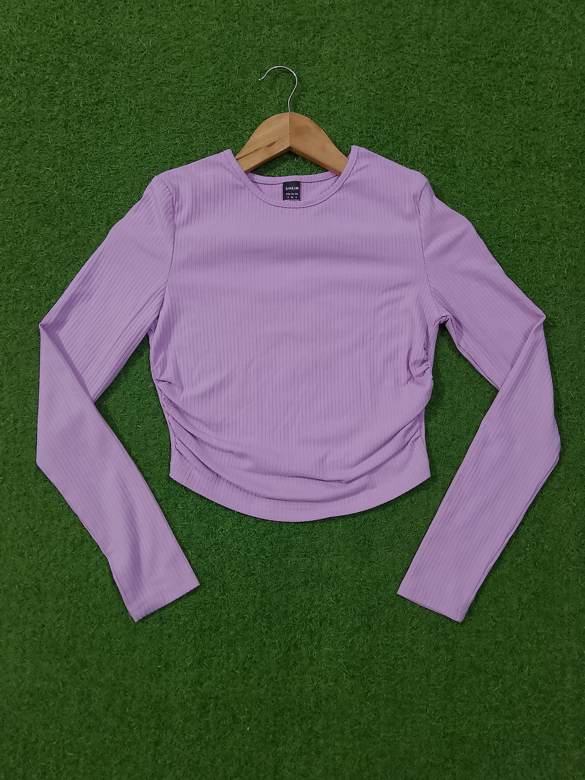 Lavender ribbed ruched long sleeve crop top on hanger